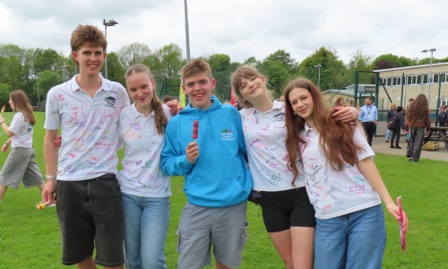 Year 11s celebrating at their end of school party, signing their t-shirts and enjoying ice creams